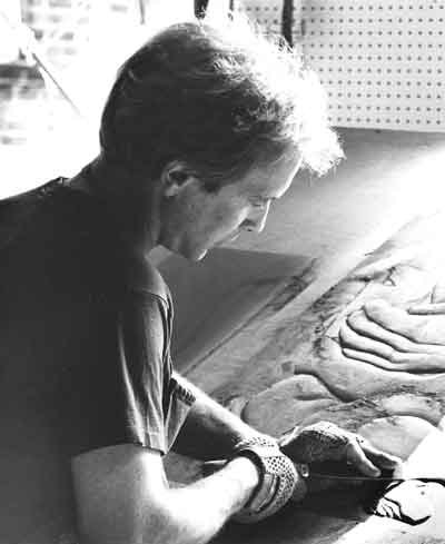 Image of Biehl carving slate bas-relief with hand chisel.