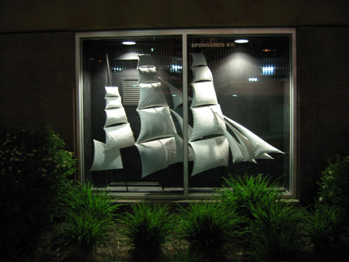 Image of an installation in a display window, featuring 
billowing sail forms of a clipper ship.